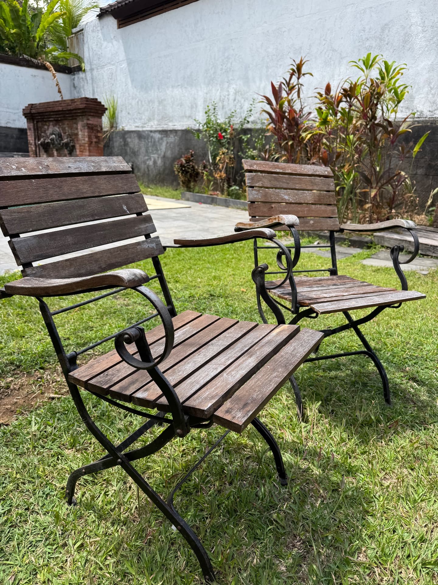 Two wood and wrought iron chairs